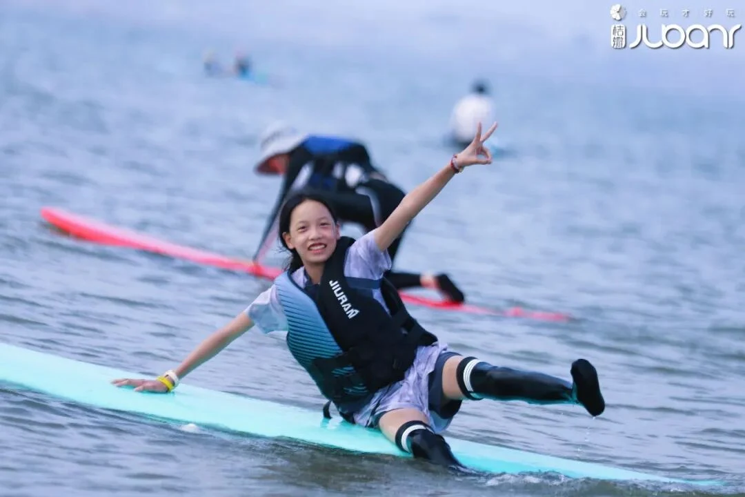 孩子在海边冲浪时张开双臂